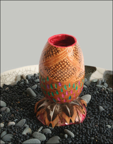 gourd cup with grouse feathers